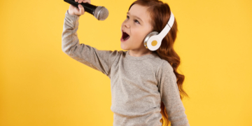 joyful girl headphones is singing karaoke scaled