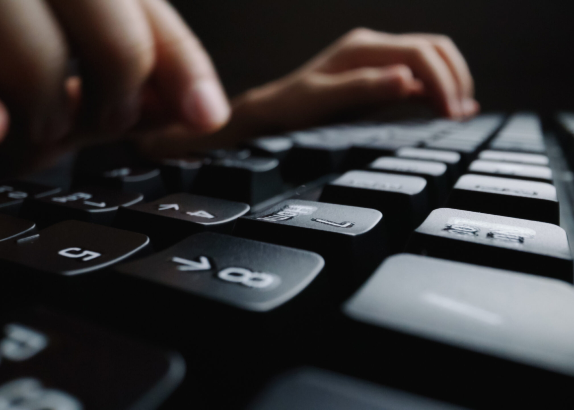 close up soft focus finger typing keyboard scaled